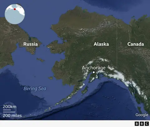 Map showing Alaska, Canada, and Russia with the Bering Sea in between. Anchorage is marked in southern Alaska. The map highlights how Alaska and Russia are geographically close, separated by only a narrow stretch of water. An inset globe in the top left shows the region’s location in the northern Pacific