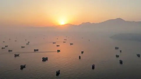 Vessels in the Strait of Hormuz, as seen from Musandam, Oman, June 15, 2026