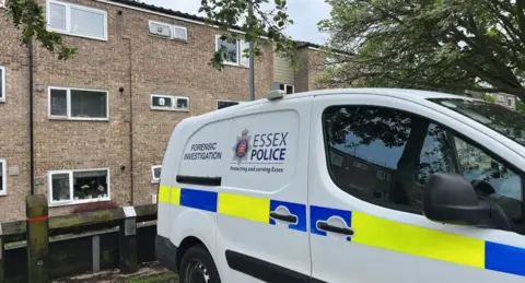Richard Knights/BBC Police car parked outside property in Colchester