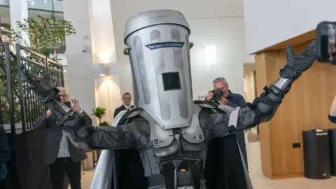 PA Media UK election candidate Count Binface dressed with a silver bin on his head and arms spread out wide at City Hall, London.
