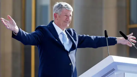 Getty Images Political ally Philippe de Villiers delivers a speech during an election campaign rally of Eric Zemmour on ‘Place du Trocadero’ in front of the Eiffel Tower , on March 27, 2022 in Paris, France. 