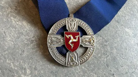 Dave Martin's captain of the parish badge