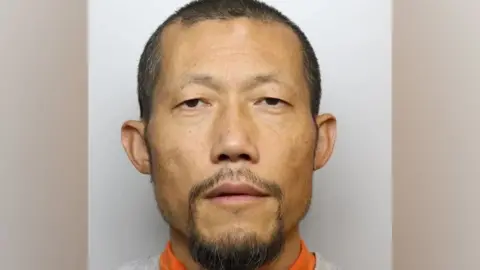 Wiltshire Police Police mugshot of Hongchi Xiao looking into the camera