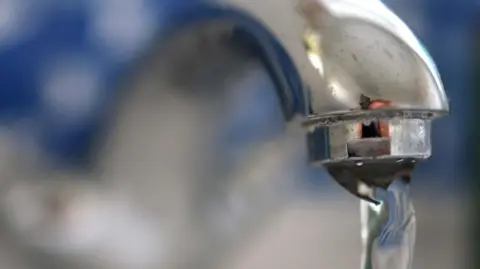 EPA Water pours from a silver tap.