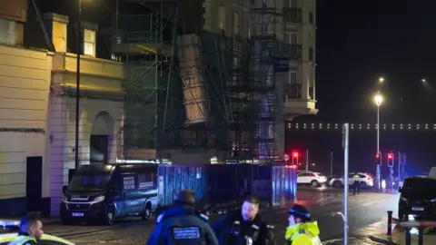 Eddie Mitchell Police officers on Cannon Street, next to a large unbalanced bit of scaffolding. 