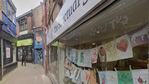 A City of Sanctuary office with children's Valentine's messages displayed in the window