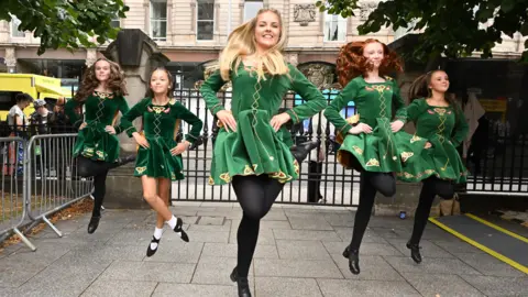 Oliver McVeigh/PA Wire Five Irish dancers in green dresses and black tights.