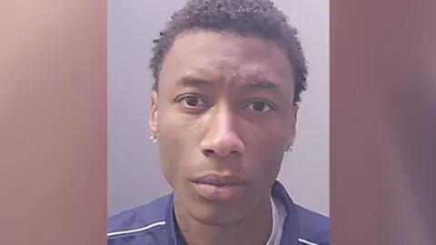 Cambridgeshire Police Close-up image of Heraldo Alves Te wearing a blue jacket with white trim. 