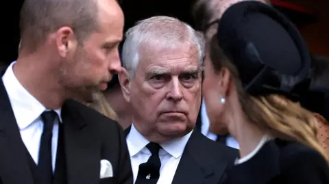 Reuters Close-up shot of Andrew between the Prince of Wales and Catherine, Princess of Wales.