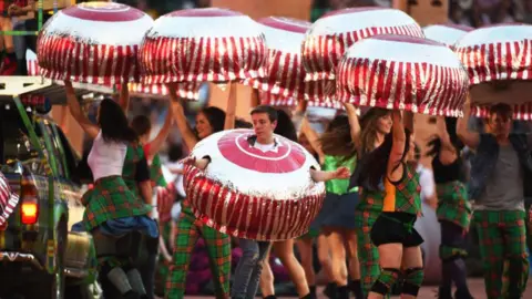 Getty Images Dancers dressed as tea cakes dance around, during an opening ceremony event for the Commonwealth Games in Glasgow