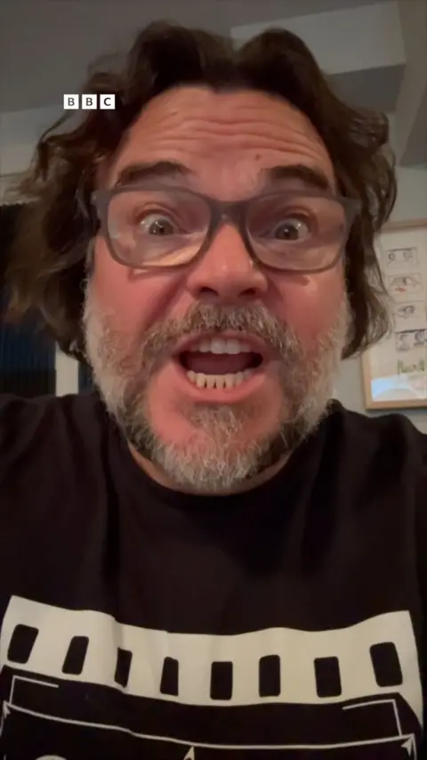 A selfie of Jack Black wearing light grey glasses.