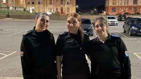 North Wales Police Three young female officers stood together before heading off for a run.