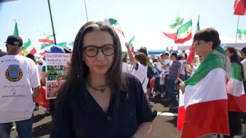 Shaimaa Khalil surrounded by protesters waving flags