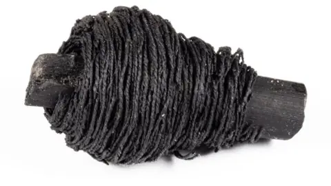 Peterborough Museum & Art Gallery Bronze Age blackened thread wrapped around a blackened wooden stick from Must Farm