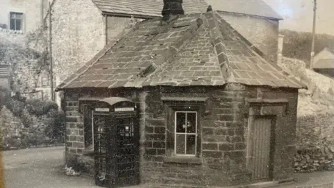 Toll Bar Chippy Black and white picture of small octagonal building