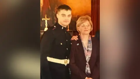 Juliette Murphy Man in army uniform, Philip, stands with older woman (unknown). He is a young man in the photo.