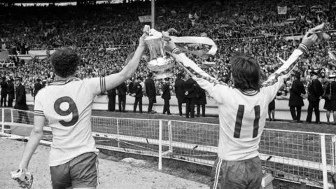 Getty Images A black and white image from 1976 of Saints players holding the FA Cup aloft.