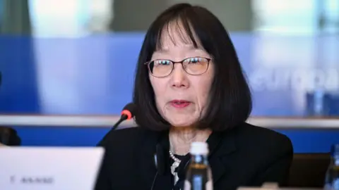 Judge Tomoko Akane  at the microphone at an event in Brussels