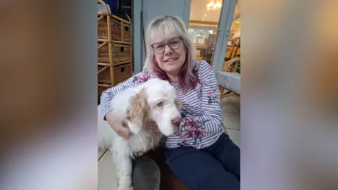 Barbara Weston Barbara Weston, sat at home, hugging her Clumber spaniel Chloe