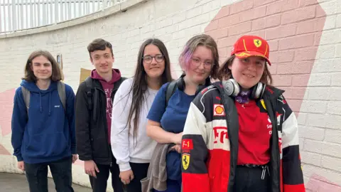 Jon Wright/BBC Aaron, Leo, Leonor, Ink and Kayley, stand in a line against an underpass wall