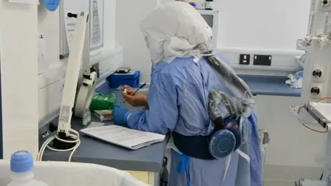 Staff member at a work station in Glan Gwili hospital in Carmarthen at the height of the Covid pandemic 