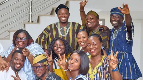 NHIS A group of workers pose for the camera in their fugus at the office's of Ghana's National Health Insurance Scheme (NHIS) in Accra, Ghana.