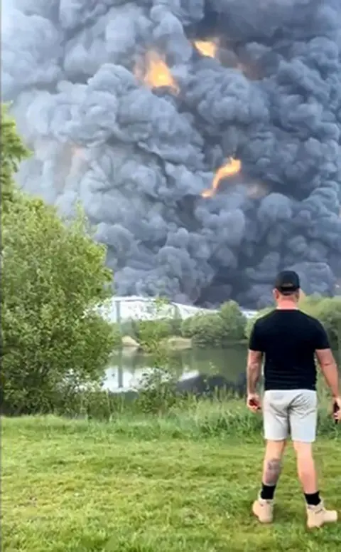 PA/@SamWinter_1  Smoke from the fire with a man within the foreground