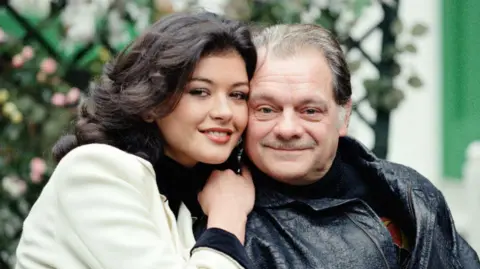 Getty Images Jones with David Jason in character. Jones, on the left, wears a white jacket and has dark brown wavy hair. Jason, on right, wears a black leather jacket and has short grey hair and a moustache. 