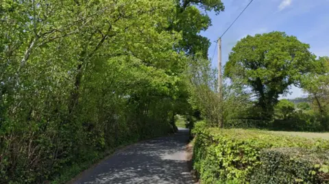 The A382, with hedges either side of the road, near Chagford in Devon