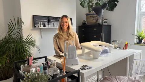 Jessie-Mae Lambert sitting in her nail studio at home in Chester Green, Derby