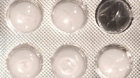 Close up of a blister pack of white tablets with one of the windows empty. The plastic package which features a dimpled, foil wrapper, contains five round tablets.