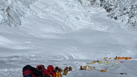 This photograph taken on May 31, 2021 shows mountaineers climbing a slope lined up during their ascend to summit Mount Everest (8,848.86-metre), in Nepal
