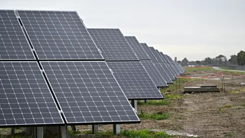 Getty Images A row of solar panels in a field