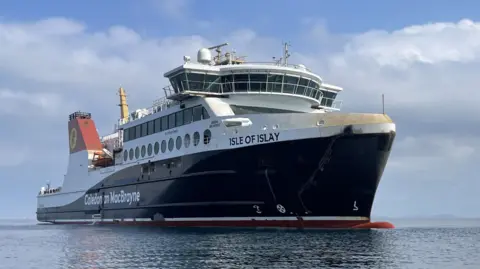 CMAL A large black and white ship with red funnels, with MV Isle of Islay written on the bow