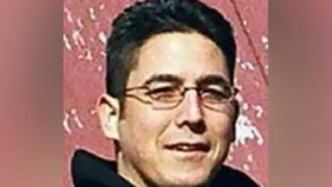 FBI Close up of Daniel Andreas San Diego shortly after he went on the run in 2003. Shows San Diego, who is no 47, with close cropped short black hair and narrow rectangle wire rimmed glasses.