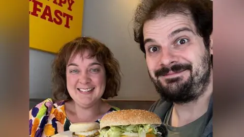 Anthony Zupnik Claire and Antony Zupnik holding Wimpy meals