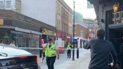 A police cordon is in place and police officers are at the scene of a stabbing on Abington Street in Northamptonshire. 