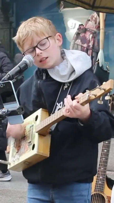 Young boy playing guitar