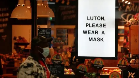 Reuters 'Luton, Please wear a mask' sign in a LUSH shop window 