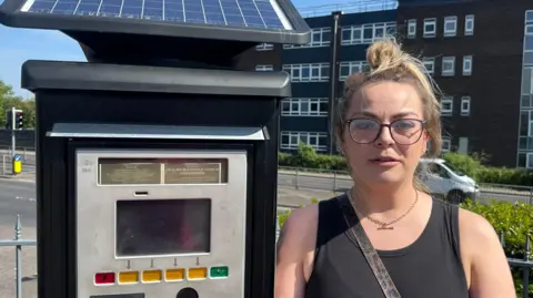 BBC Nicola Green, standing by one of the ticket machines