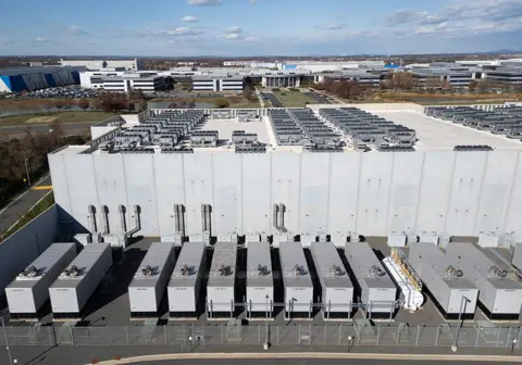 AFP via Getty Images An aerial view shows cooling vent fans on the roof next to generators on the lower level of a Digital Realty data centre in Ashburn, Virginia