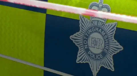 Close up of the Nottinghamshire Police badge on the side of a patrol car