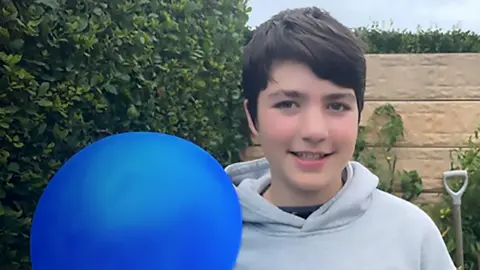 Sonia 12-year-old Danny with blue balloon