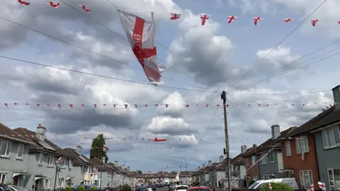 Rows of England flags are strung across Wroxham Avenue in Grimsby