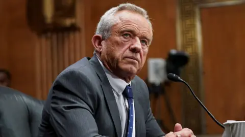 Robert F Kennedy Jr in front of a microphone at a senate hearing last week