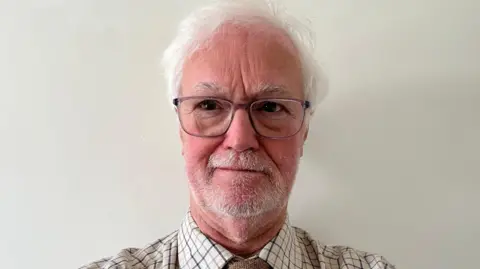 Robin Legg Robin Legg, a grey haired man in a shirt, tie and glasses.