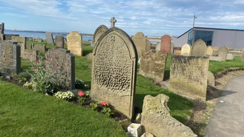 A graveyard with eroded gravestones 