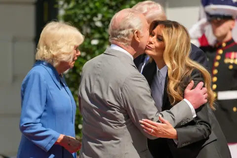 Getty Images King Charles III embraces first lady Melania Trump before departing a farewell ceremony at the White House on the final day of the state visit of King Charles III and Queen Camilla on April 30, 2026 in Washington, DC.