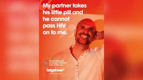 Finn Crawley & Benji Graphics A HIV poster. A man is pictured with one hand on his head, looking at the camera and smiling. The poster is orange and red, with white text reading: "My partner takes his little pill and he cannot pass HIV on to me." There is also a Brigstowe charity logo and a message to say "People taking HIV medication CANNOT pass on the virus" 