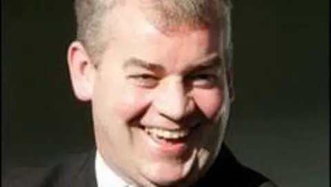 Stephen Vaughan, who has short grey hair, smiles at the camera